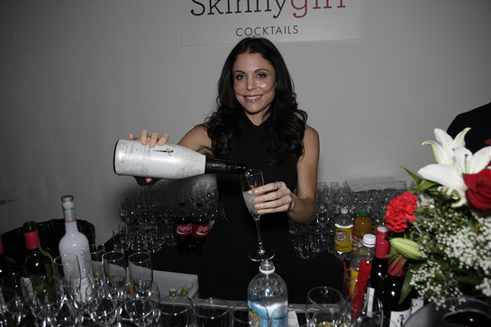 Guest mixologist Bethenny Frankel jumps behind the Skinnygirl® Cocktails bar at Dress for Success' Shop for Success VIP Party on Saturday, November 9, 2013 in New York City. 