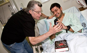 King autographs a copy of his new book for Navy Lt. J.G. Pablo Yepez of Bayone, N.J.