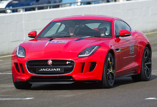 Prince Harry drives a Jaguar F-Type car as he attends The Royal Foundation Endeavour Fund track day at Goodwood Motor Circuit