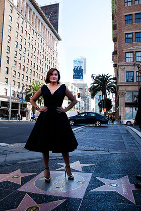 Mariska Hargitay in front of the three-story NO MORE PSA campaign billboard located atop the 1600 VINE apartment complex at Hollywood and Vine.