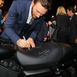 Chris Evans Signs Harley-Davidson For Charity At Captain America Premiere