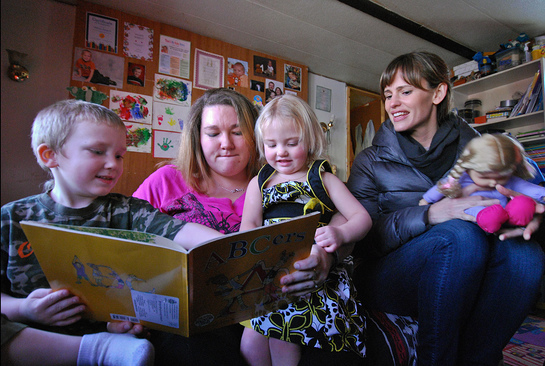 Save the Children Board of Trustees member Jen Garner visits with Lynmarie Sargent, 30, and her children at their home in Henderson, WV.