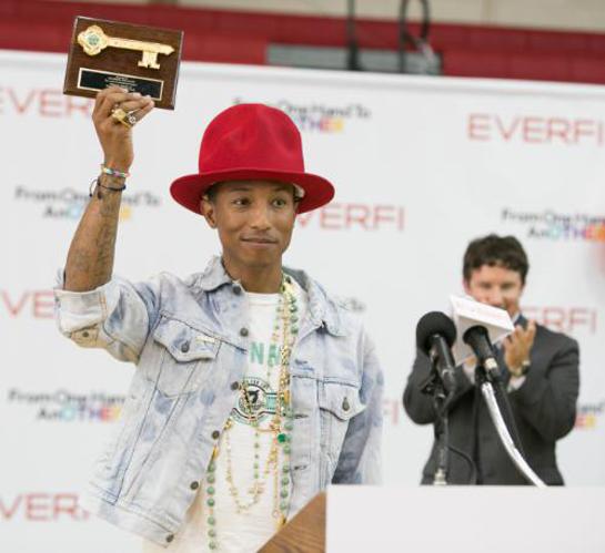 Virginia Beach Mayor Will Sessoms presents Pharrell Williams with a key to the city during a kickoff event at Princess Anne High School