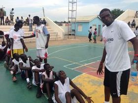 Luol Deng coaching kids at a basketball camp in Juba, South Sudan