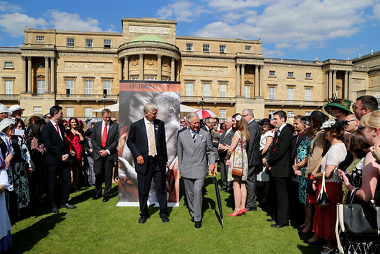 The Prince of Wales greets guests at the British Red Cross garden party