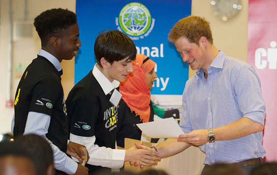 Prince Harry poses for a group photograph during a visit to Bethnal Green Academy