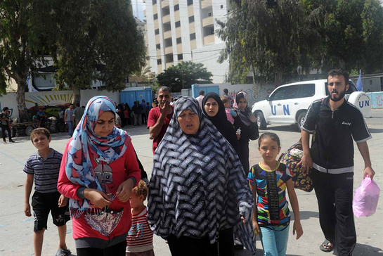 Palestinian families seek shelter at an UNRWA school after evacuating their homes north of the Gaza Strip