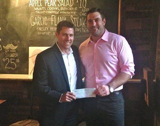 Chris Bratton, from Rothamel Bratton, LLC presents a check to Todd Herremans