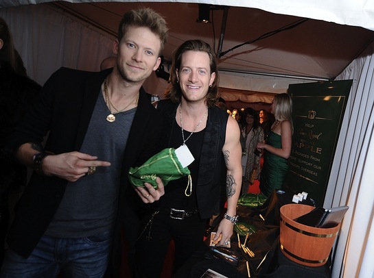 Brian Kelley and Tyler Hubbard of Florida Georgia Line take a moment to pack a Crown Royal Regal Apple care package
