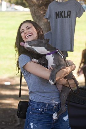 Emmy Rossum is smothered with kisses from an adorable pit pull puppy at the Best Friends NKLA Adoption Weekend