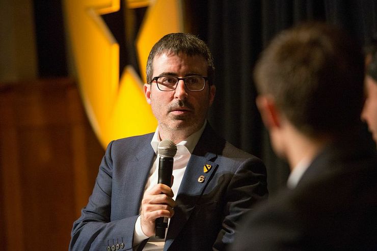 Comedian John Oliver interviewing a veteran on stage during the second annual Got Your 6 Storytellers event