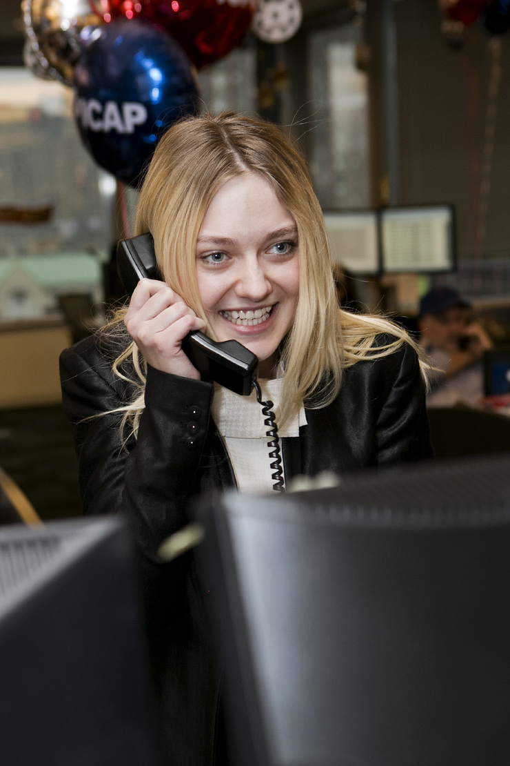 Dakota Fanning answers the phones on the trading floor at ICAP’s North American headquarters in Jersey City, NJ