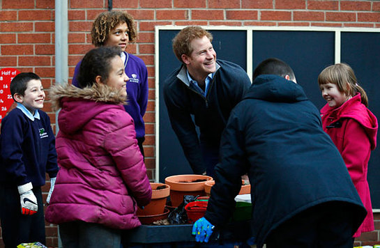 Prince Harry laughs with youngsters involved in a garden project during a visit to the Full Effect Youth Projec Prince Harry laughs with youngsters involved in a garden project during a visit to the Full Effect Youth Projec