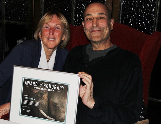 PETA President Ingrid E. Newkirk presenting Sam Simon with a certificate