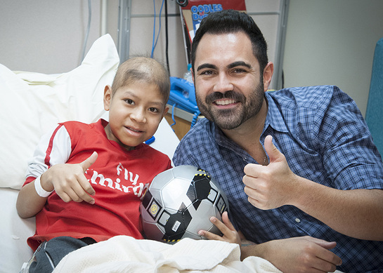 Enrique Santos shares his love with St. Jude patient Anderson