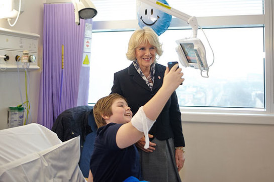The Duchess of Cornwall has her photo taken with a teenage patient during her visit to Arthritis Research UK