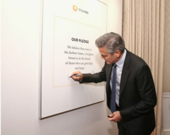 Clooney signs the 100 Lives pledge: 