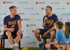 Marc-Andre ter Stegen and Andres Iniesta speak with children during an an event organized by FC Barcelona and UNICEF