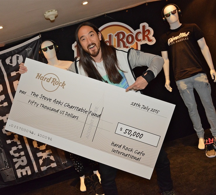 American electro house musician Steve Aoki accepts a $50,000 check