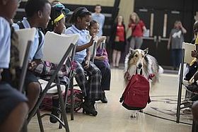 Lassie Carries a Disaster Supply Kit into a Save the Children Prep Rally, Treme Community Center, New Orleans