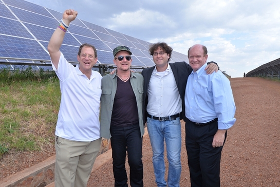 Bono with Gigawatt Global co-founders Yosef Abramowitz and Chaim Motzen, plus Chris Coons at East Africa's first solar field near Kigali, Rwanda