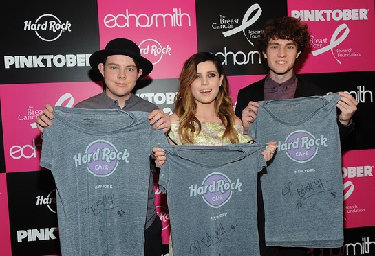 Echosmith poses with signed PINKTOBER merchandise at the launch of Hard Rock International's 16th annual breast cancer awareness campaign